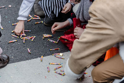 High angle view of people picking candies from street during carnival