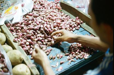 Midsection of person for sale at market stall