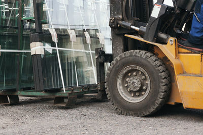 Worker driving forklift and loading glass constructions