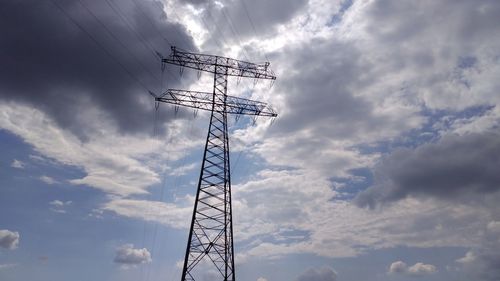 Low angle view of electricity pylon against sky