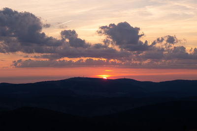 Scenic view of silhouette mountains against sky during sunset