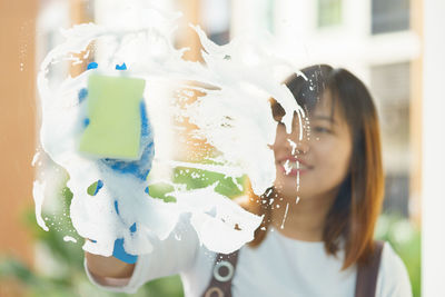 Woman cleaning glass window