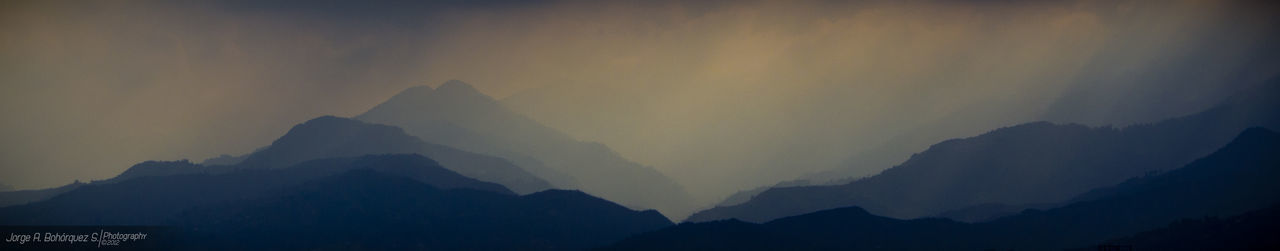 Scenic view of mountains against dramatic sky