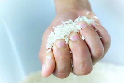 Cropped hand holding rice