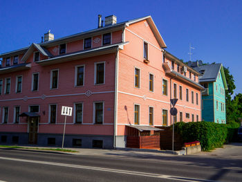 Street amidst buildings against clear sky