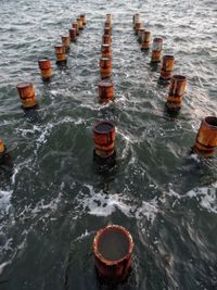 High angle view of wooden posts in sea