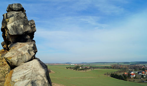 Scenic view of rocks on field against sky