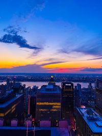 High angle view of illuminated buildings against sky during sunset