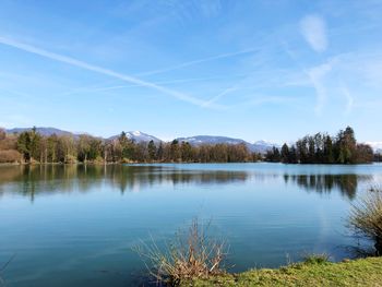 Scenic view of lake against blue sky