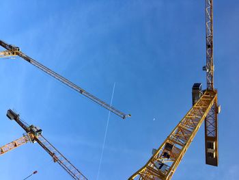 Low angle view of crane against sky