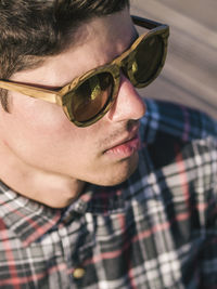 Close-up of fashionable young man wearing sunglasses during summer