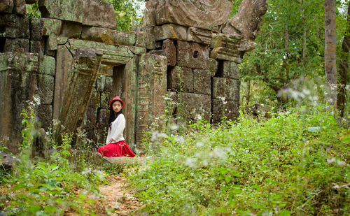 Woman standing by old ruins