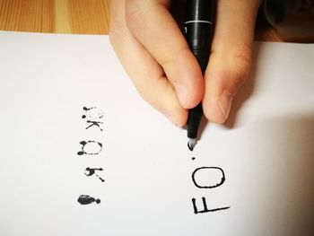 Close-up of human hand on paper