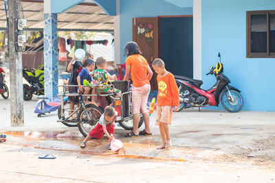 Rear view of people with umbrella on street