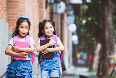 Portrait of a smiling girl standing outdoors