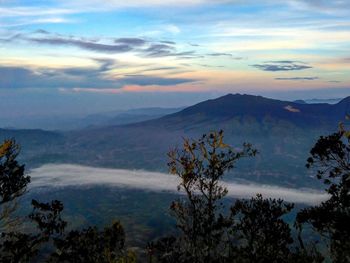 Scenic view of mountains against sky at sunset