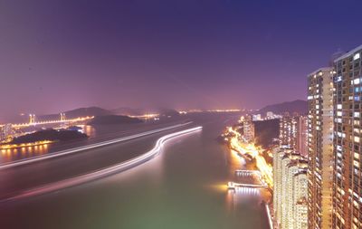 Illuminated cityscape against sky at night