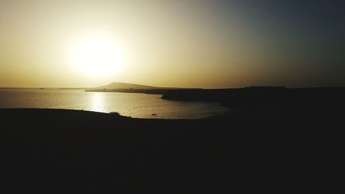 Scenic view of sea against clear sky during sunset