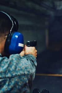 Rear view of man practicing target shooting