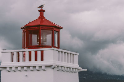 Low angle view of building against cloudy sky