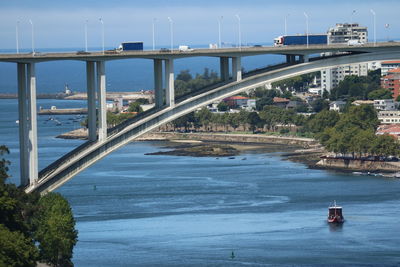 Bridge over sea against sky in city