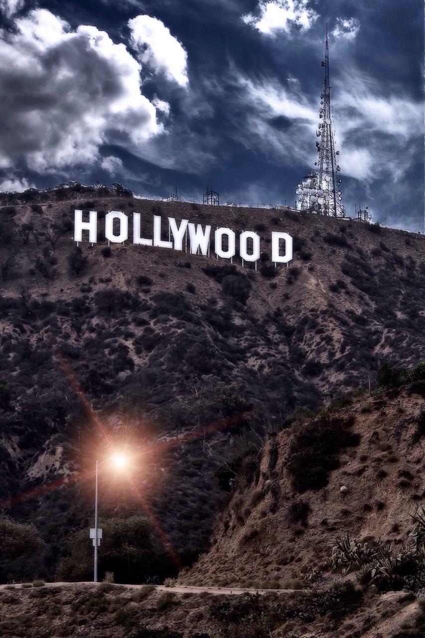 text, communication, western script, sky, cloud - sky, guidance, sign, information sign, low angle view, road sign, directional sign, information, arrow symbol, cloudy, capital letter, cloud, built structure, no people, outdoors, architecture