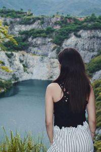 Rear view of woman looking at waterfall