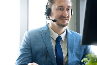 Portrait of smiling man using smart phone