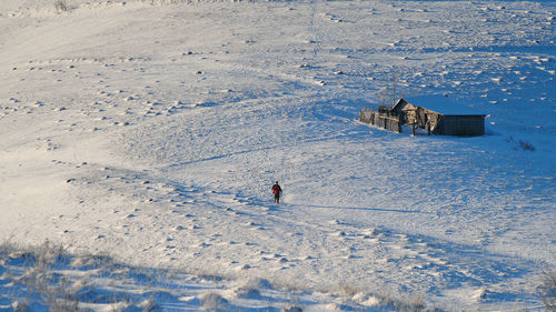 High angle view of person on snow covered field