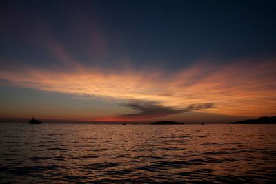 Scenic view of sea against romantic sky at sunset