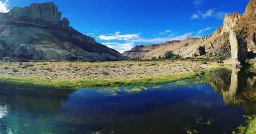 Scenic view of lake and mountains against sky