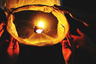 Close-up of illuminated lamp at night