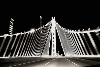 Illuminated suspension bridge at night