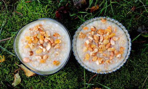 Directly above shot of breakfast served in bowls on grassy field