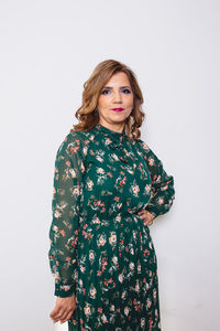 Portrait of woman standing against white background