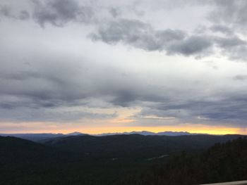 Scenic view of silhouette mountains against sky at sunset