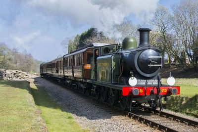 Train on railroad track against sky