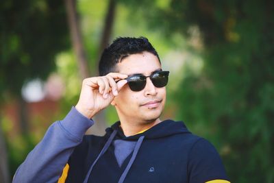 Portrait of man wearing sunglasses standing outdoors