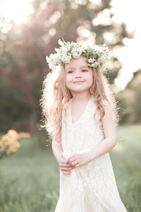 Cute girl wearing wreath at park