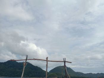 Low angle view of telephone pole against sky