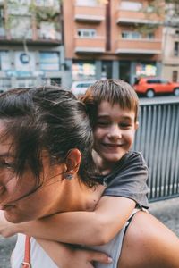 Close-up of mother and son outdoors