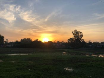 Scenic view of field against sky during sunset