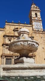 Low angle view of historical building against blue sky