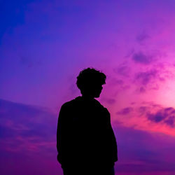 Silhouette man standing against dramatic sky