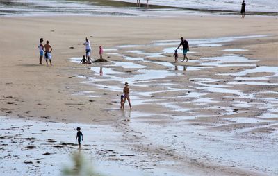 High angle view of people walking on beach