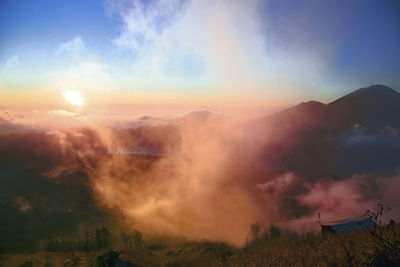 Scenic view of agung volcano and batur lake at mist morning sunrise, bali, indonesia