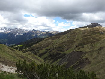 Scenic view of mountains against cloudy sky