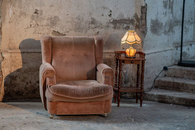 Empty chairs against wall in abandoned room