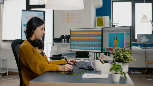 Woman working on table in office