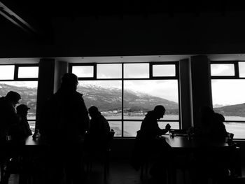 Silhouette people sitting in restaurant